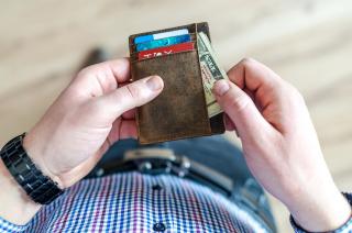 Man taking money out of a wallet