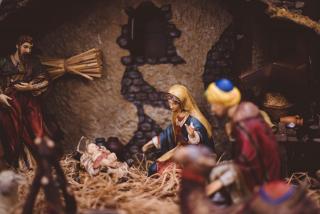 A close-up of a nativity creche, with the Holy Family figures and baby Jesus