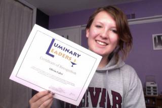 Olivia Calvi holds her Luminary Leaders Certificate of Recognition.