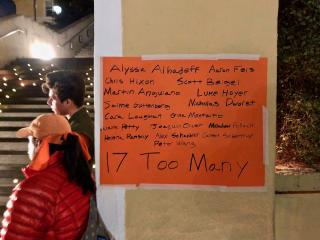 On a poster next to a candlelight vigil, the names of the 17 people killed by a shooter in Parkland, Florida
