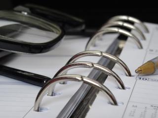 Center of of binder with pen and glasses