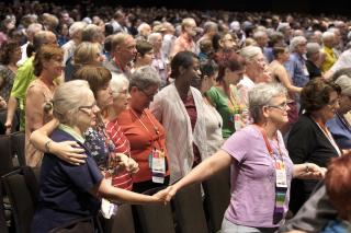 people in prayerful poses at GA 2017