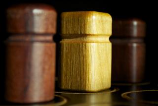 Close up photo of wooden game pieces from Quarto.