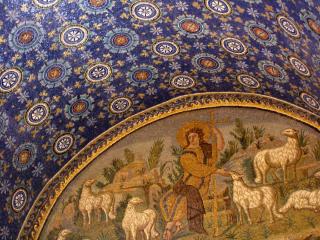 A mosaic ceiling, in bright blue and white patterns, with a gold arced inset of a shepherd with sheep