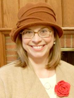 Sharon Dittmar in hat, wearing rose
