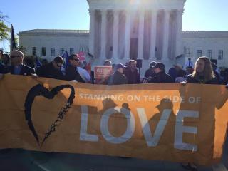 Protesters hold a Standing on the Side of Love banner outside the US Supreme Court