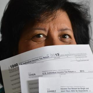 Woman holding tax return forms