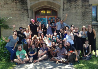 a group of young adults, half people of color and half white, are making fun faces outside of a church