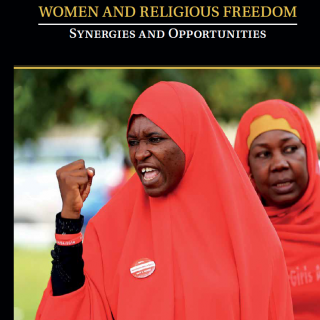 A photo shows a member of the #BringBackOurGirls Abuja campaign group raising her fist during a protest on the cover of a report entitled "Women and Religious Freedom: Synergies and Opportunities"