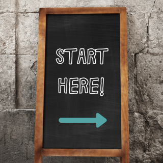 Chalkboard saying Start Here with an arrow