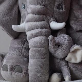 Toy stuffed elephant snuggling a calf