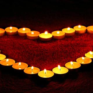 votive candles arranged in the shape of a heart