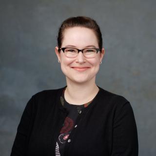Smiling, and wearing glasses, Sarah Skochko in a portrait setting.