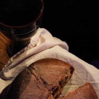A loaf of bread and goblet of juice for communion at church.