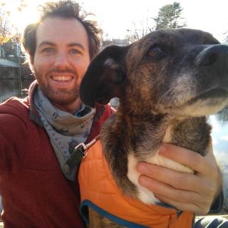 Outdoors, smiling widely, Zeb Green includes their cute dog in a selfie.