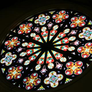 Multicolored circular stained glass window. One of the magnificent rose windows at UU San Francisco.  