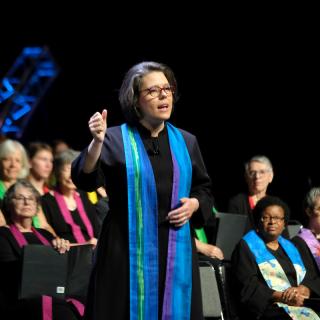 President Susan Frederick-Gray preaching on stage at GA 2018