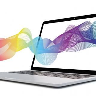 Laptop with rainbow wave graphic flowing through the screen