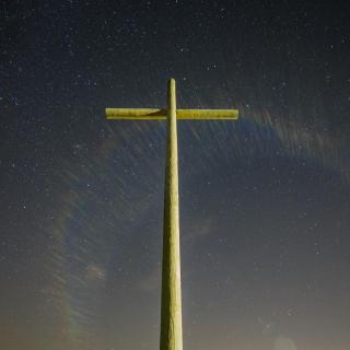 A stark cross against a starry night sky
