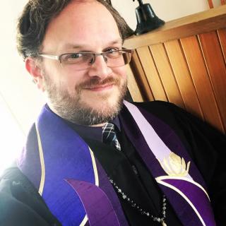 Rev. David Kohlmeier, smiling, in vestments