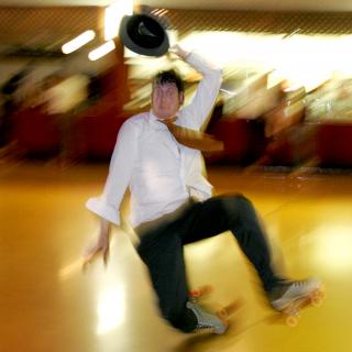 A blurry photograph of a roller skater in mid-fall