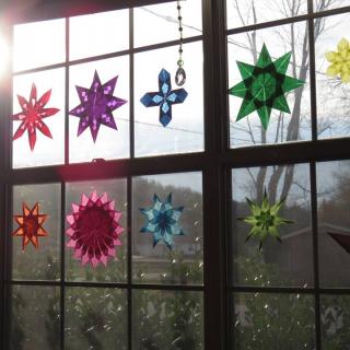 colorful stars hanging in the panes of a window