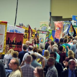 Participants carry congregational banners into the Opening Celebration