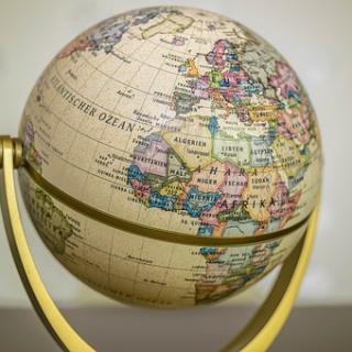 A world globe on a golden stand, with Africa and the Middle East facing us.
