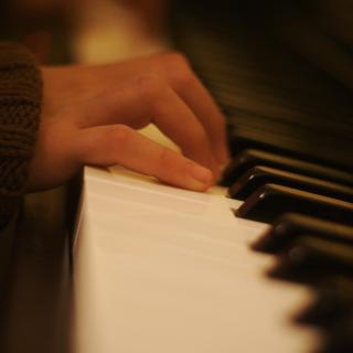 A close-up of hands playing the piano