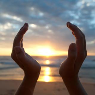 Hands holding the sunrise
