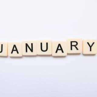 Scrabble letters spell out the word "January."