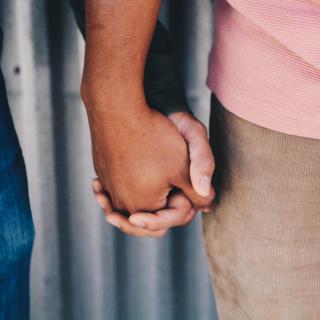 Photo of two people holding hands