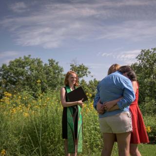 Minister stands in a field of flowers to marry a same sex couple when SCOTUS ruled on marriage equality.