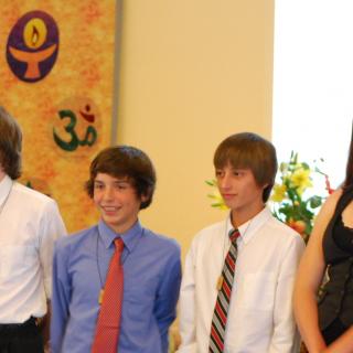 Six youth pose wearing flaming chalice pendants after their Coming of Age service.