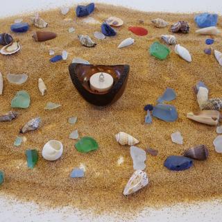 altar with sand, chalice, sea glass and shells