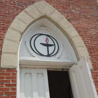 Front door of a UU church with chalice