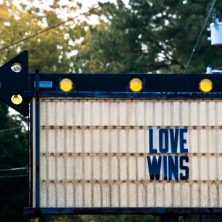 A marquee that says "LOVE WINS"