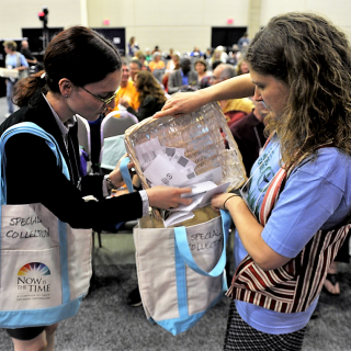 two ushers put the special collection in tote bags during 2013 GA plenary